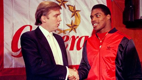 Then-New Jersey Generals owner Donald Trump (left) shakes hands with Herschel Walker at a 1984 press conference in New York, after agreeing on a 4-year contract.