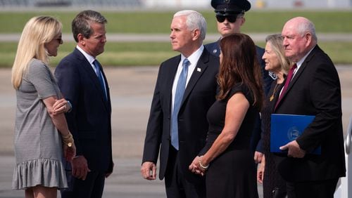 Vice President Mike Pence and his wife, Karen, speak with Gov. Brian Kemp and his wife, Marty, as Secretary of Agriculture Sonny Perdue and his wife, Mary, stand behind them after arriving at Dobbins Air Reserve Base in Marietta on Friday.Ben Gray for The Atlanta Journal-Constitution