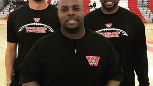 Byran Love (center) is new coach at Woodland. (Photo courtesy Woodland Facebook page.)