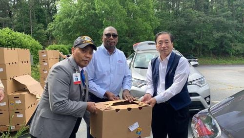 Norcross Mayor Craig Newton joined forces recently with the Korean American Association of Greater Atlanta, President Charlie Yoon Kim of Korea American Association and Solicitor General Brian Whiteside along with volunteers to distribute 2400 food boxes to those in need. (Courtesy City of Norcross)