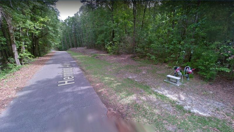 A May 2013 Street View image shows a memorial at the rural spot in Ozark, Alabama, where the bodies of J.B. Beasley and Tracie Hawlett, both of Dothan, were found shot to death Aug. 1, 1999, in the trunk of Beasley's car. The 17-year-old girls went missing the night before after getting lost on their way to a party in a neighboring city. Ozark police officials on Monday, March 18, 2019, announced the arrest of Coley Lewis McCraney, 45, of Dothan, in the slayings. At the time of the teens' deaths, McCraney lived about a mile from where the abandoned car was found.