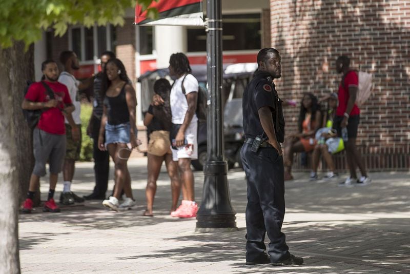 A Clark Atlanta University Police officer keeps an eye out as students socialize near the Clark Atlanta University student center on the main campus in Atlanta, Wednesday, August 21, 2019. The night before, a shooting took place on the promenade, an area near the library, injuring 2 Clark Atlanta University students and 2 Spelman College students. (Photo: Alyssa Pointer/alyssa.pointer@ajc.com)