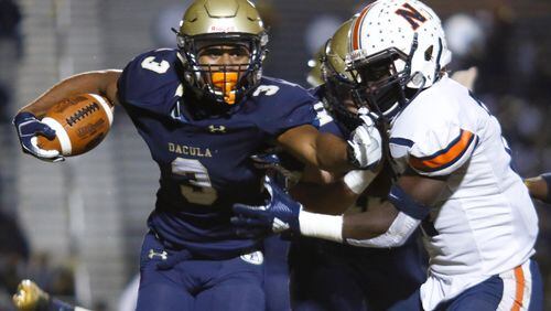 Dacula's Jalen Perry (3) pushes away a Northside defender during the first half of Friday's Class AAAAAA semifinal in Dacula. (Casey Sykes/Special)