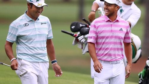 Hideki Matsuyama and Xander Schauffele share a laugh after they both made eagle putts on the 15th green during the third round of the Masters on Saturday, April 10, 2021, in Augusta.   “Curtis Compton / Curtis.Compton@ajc.com”