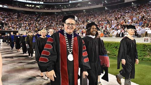 Jere Morehead, president of the University of Georgia, and Deborah Ann Roberts (second from left), commencement speaker, leave after UGA's 2019 spring undergraduate commencement ceremony at Sanford Stadium in Athens on Friday, May 10, 2019. (Hyosub Shin / Hyosub.Shin@ajc.com)
