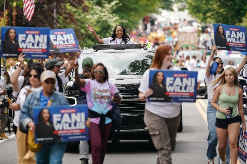 Fulton County District Attorney Fani Willis (in vehicle) and her supporters campaign during a recent parade in Atlanta.