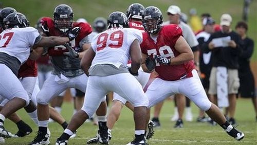 Atlanta Falcons center Joe Hawley (61) and guard Mike Johnson (79) block defensive tackle Trey Lewis (97) and defensive tackle Vance Walker (99) during NFL football training camp in Flowery Branch, Ga., Wednesday, Aug. 4, 2010. (AP Photo/Paul Abell) Atlanta Falcons center Joe Hawley (61) and guard Mike Johnson (79) block defensive tackle Trey Lewis (97) and defensive tackle Vance Walker (99) during NFL football training camp in Flowery Branch, Ga., Wednesday, Aug. 4, 2010. (AP Photo/Paul Abell)