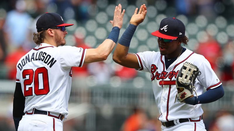 Braves teammates Josh Donaldson and Ronald Acuna celebrate a 6-5 victory over the Pittsburgh Pirates Thursday, June 13, 2019, at SunTrust Park in Atlanta.