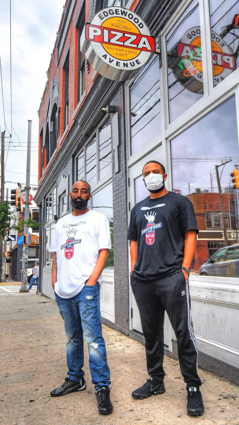 Edgewood Pizza owner Adonay Deglel (left), aka Bob Castanza (what everyone in the neighborhood calls him), and business partner Natnael Tekeste pose outside Edgewood Pizza, 478 Edgewood Ave. in the Old Fourth Ward area of downtown Atlanta. Deglel, an Eritrea-born businessman, has owned and operated the pizza parlor for the past 17 years. CONTRIBUTED BY CHRIS HUNT PHOTOGRAPHY