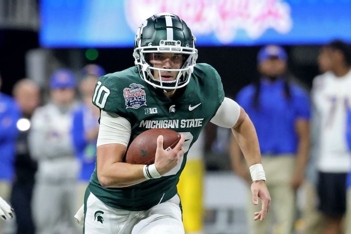Michigan State Spartans quarterback Payton Thorne (10) runs for yards during the first half against the Pittsburgh Panthers of the Chick-fil-A Peach Bowl at Mercedes-Benz Stadium in Atlanta, Thursday, December 30, 2021. JASON GETZ FOR THE ATLANTA JOURNAL-CONSTITUTION