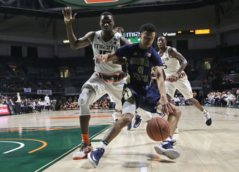  Georgia Tech's Justin Moore (0) loses control of the ball as Miami's Ebuka Izundu defends during the first half of an NCAA college basketball game, Wednesday, Feb. 15, 2017, in Coral Gables, Fla. (AP Photo/Lynne Sladky)
