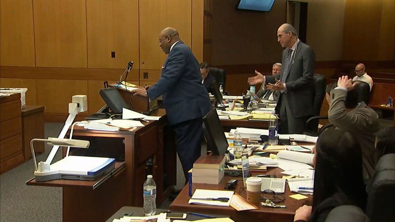 Defense attorney Bruce Harvey (standing, right) objects during lead prosecutor Clint Rucker's (standing at podium) questioning of witness Darrin Smith. Smith, an APD homicide detective, was testifying during the murder trial of Tex McIver on March 30, 2018 at the Fulton County Courthouse. (Channel 2 Action News)