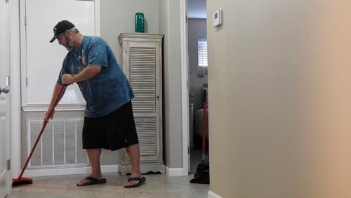 Mark Jones cleans an AirBnB, Monday, March 2, 2020, in Port Aransas, Texas. Jones' niece helped him get work when he was released from prison in 2017.