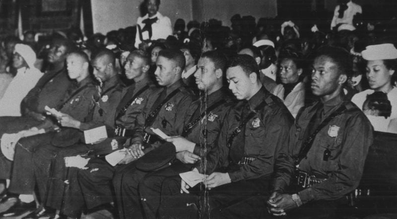 Atlanta's first eight black police officers listen to speakers during an NAACP-sponsored program honoring them at Greater Mount Calvary Baptist Church April 30, 1948. Left to right: Willie Elkins, Willard Strickland, John H. Sanders, Robert McKibbens, Ernest Lyons, Johnnie P. Jones, Henry Hooks, Claude Dixon. (Special photo by W.A. Scott III)