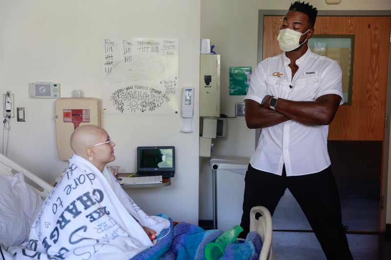 NFL Hall of Famer and former Georgia Tech player Calvin Johnson chats with leukemia patient Riley Nutt, 16, while visiting  Egleston Children’s Hospital in Atlanta on Friday, September 1, 2023. (Natrice Miller/ Natrice.miller@ajc.com) 
