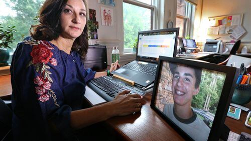 June 28, 2018 Madison: Mandi Sorohan sits next to a picture of her son, Caleb, during an interview in her office on Thursday, June 28, 2018, in Madison. Sorohan has been fighting for tougher distracted driving laws in Georgia since Caleb died in an accident while texting in 2009.    Curtis Compton/ccompton@ajc.com