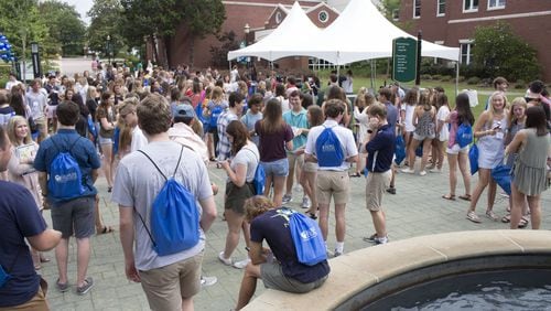 Students and parents gather around the fountain at Georgia College, which hosted its second freshmen orientation out of five for the summer on Friday, June 15. Jenna Eason / Jenna.Eason@coxinc.com