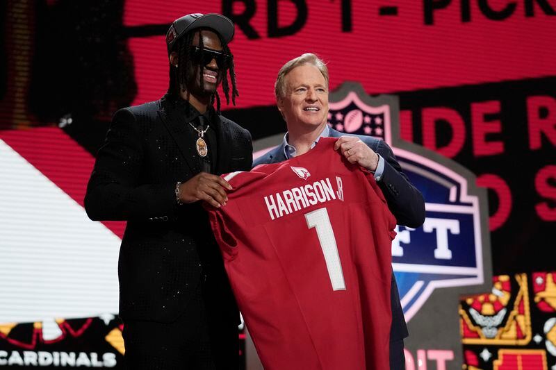 Ohio State wide receiver Marvin Harrison Jr. poses with NFL commissioner Roger Goodell after being chosen by the Arizona Cardinals with the fourth overall pick during the first round of the NFL football draft, Thursday, April 25, 2024, in Detroit. (AP Photo/Jeff Roberson)