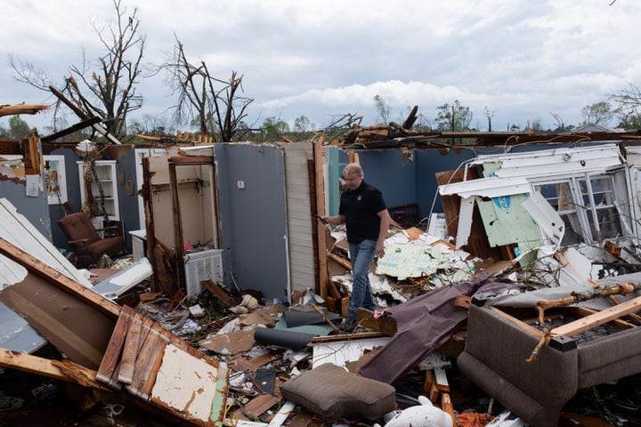 230327-West Point-Keith Stellman, meteorologist in charge of the National Weather Service office in Atlanta, surveys tornado damage to a West Point home Monday, Mar. 27, 2023, while trying to determine a rating for the tornado.  Ben Gray for the Atlanta Journal-Constitution