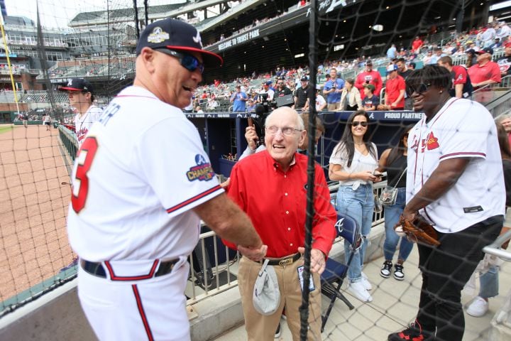 Braves manager Brian Snitker shakes hands with former UGA coach Vince Dooley before a game against the Washington Nationals at Truist Park on Wednesday, April 1, 2022. Miguel Martinez / miguel.martinezjimenez@ajc.com 