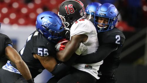 Georgia State Panthers defensive end Carnell Hopson (55) and safety Bobby Baker (2) gang tackle Ball State wide receiver KeVonn Mabon (16) after a catch during their game at the Georgia Dome, Friday, September, 2016, in Atlanta, Ga. Ball State won 31-21. PHOTO / JASON GETZ