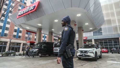 A police officer is seen Tuesday morning outside a RaceTrac gas station on Piedmont Avenue that is now closed due to safety reasons after a nearby shooting Sunday, officials said.