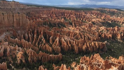 =This May 25, 2017 file photo shows a view of the world-famous hoodoos, also called tent rocks, fairy chimneys and earth pyramids, at Inspiration Point in Bryce Canyon National Park in Utah. The park has become the latest to close its gates to prevent the spread of the coronavirus.