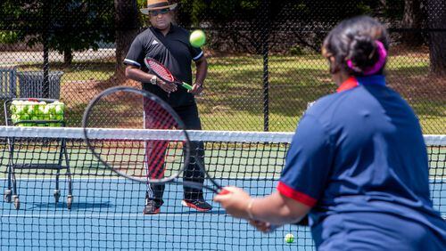 Tennis instructor Francis Ali trains his daughter Brianna during a session at the Lucky Shoals Park tennis courts in Norcross. He lost both of his legs in a bad traffic accident several years ago. Phil Skinner/For The Atlanta Journal-Constitution