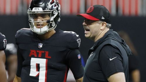 Falcons quarterback Desmond Ridder and coach Arthur Smith before the 2023 season opener against Carolina. The quarterback and the coach will open the 2024 season in different cities. (AJC file photo/Miguel Martinez)