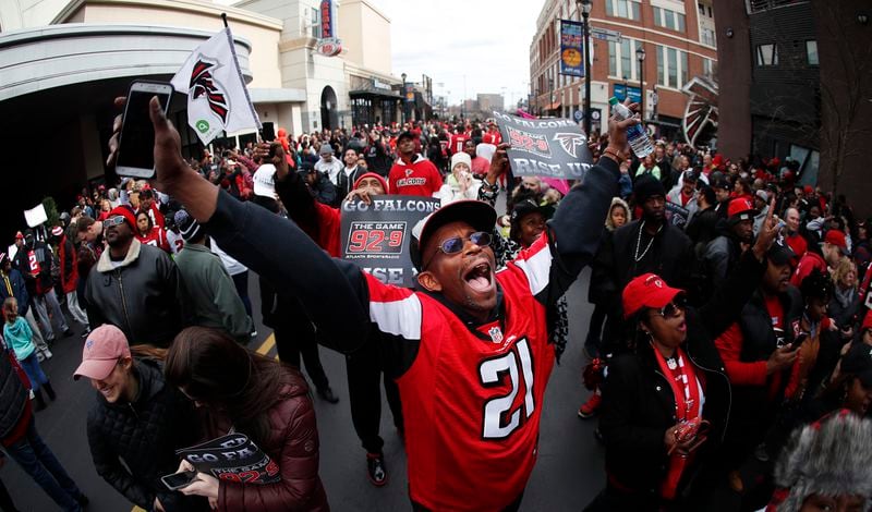 A fan cheers as he waits for buses carrying the Atlanta Falcons to pass by during a send-off pep rally for the NFL football team as they make their way to the airport for a flight to Houston and Super Bowl LI, Sunday, Jan. 29, 2017, in Atlanta. (AP Photo/John Bazemore)