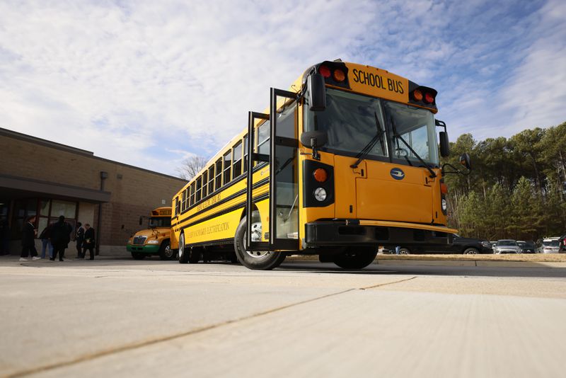 An electric bus is seen parked outside of the Stone Mountain Middle School on Monday, Jan. 8, 2024. The DeKalb County School District received a $20 million grant from the Environmental Protection Agency to purchase electric buses. (Miguel Martinez /miguel.martinezjimenez@ajc.com)