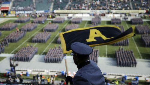 An Army cadet signals his fellows as they march onto the field before their 2015 game with Navy. (AP Photo/Matt Rourke, File)