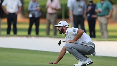 Dustin Johnson looks over a birdie putt on the 15th green during the third round of the Masters at Augusta National Golf Club on Saturday, Nov. 14, 2020, in Augusta, Georgia. (Curtis Compton/Atlanta Journal-Constitution/TNS)