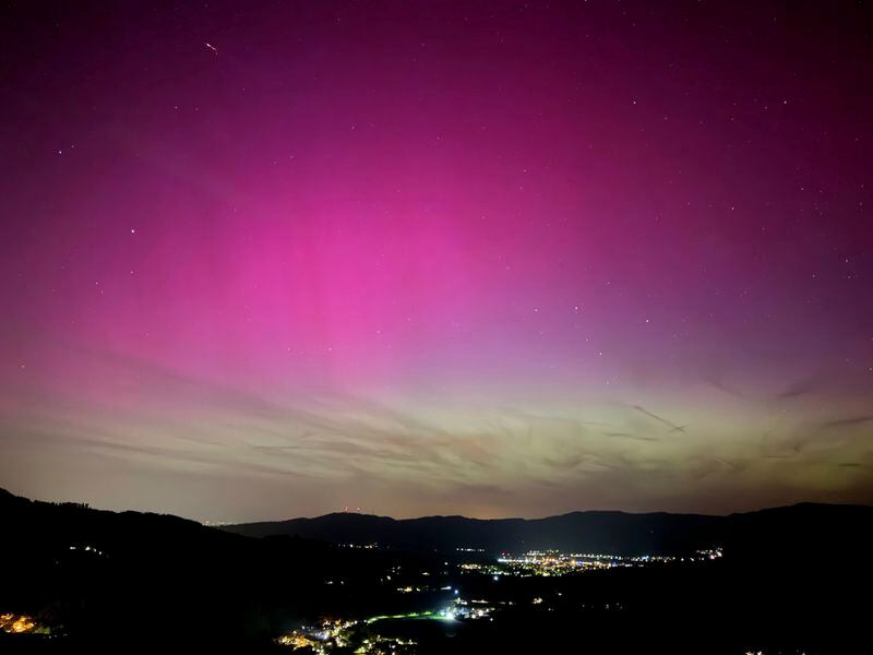 Northern lights appear over the Dreisamtal valley in the Black Forest near Freiburg, Germany, Friday evening, May 10, 2024. (Valentin Gensch/dpa via AP)