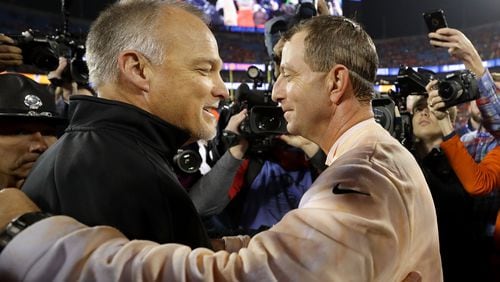 Miami's Mark Richt, left, congratulates Clemson's Dabo Swinney on a thorough whipping Saturday night. (Streeter Lecka/Getty Images)