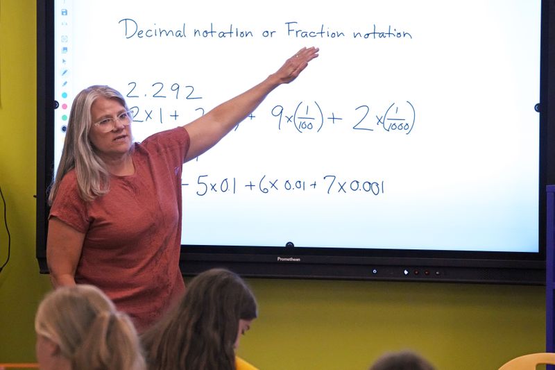 FILE - Math teacher Margie Howells teaches a fifth grade class at Wheeling Country Day School in Wheeling, WV, on Tuesday, Sept. 5, 2023. On Friday, May 3, 2024, the U.S. government issues its April jobs report. (AP Photo/Gene J. Puskar, File)