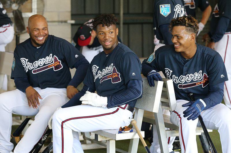 Yes, there is work to be done but that doesn't mean former Braves outfielder Andruw Jones (from left) and outfielders Ronald Acuna and Cristian Pache can't yuk it up in the batting cages. (Curtis Compton/ccompton@ajc.com)