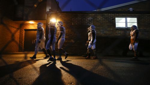 Members of the Lanier varsity football team head back to the locker room before the start of a high school football game between Lanier and Dacula at Dacula High School in Dacula, Ga., on Friday, Oct. 26, 2018. (Casey Sykes for The Atlanta Journal-Constitution)