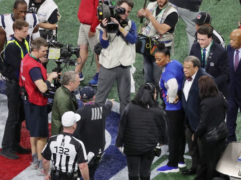 Bernice King, in blue jersey at right, stands next to Andrew Young on the field before the New England Patriots played the Los Angeles Rams in Super Bowl LIII on Sunday, Feb. 3, 2019 at Mercedes-Benz Stadium    (JOHN SPINK/JSPINK@AJC.COM)