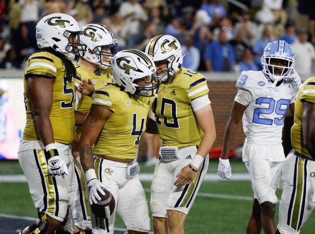 Georgia Tech Yellow Jackets running back Dontae Smith (4) celebrates with teammates after his  touchdown on a 70-yard run during the fourth quarter.  (Bob Andres for the Atlanta Journal Constitution)