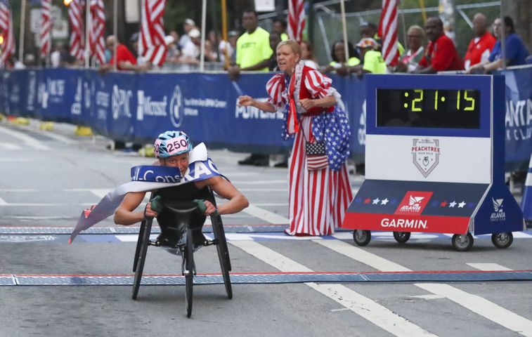Susannah Scaroni wins the women's elite wheelchair race, setting a record in the 53rd running of the Atlanta Journal-Constitution Peachtree Road Race in Atlanta on Monday, July 4, 2022. (Curtis Compton / Curtis.Compton@ajc.com)