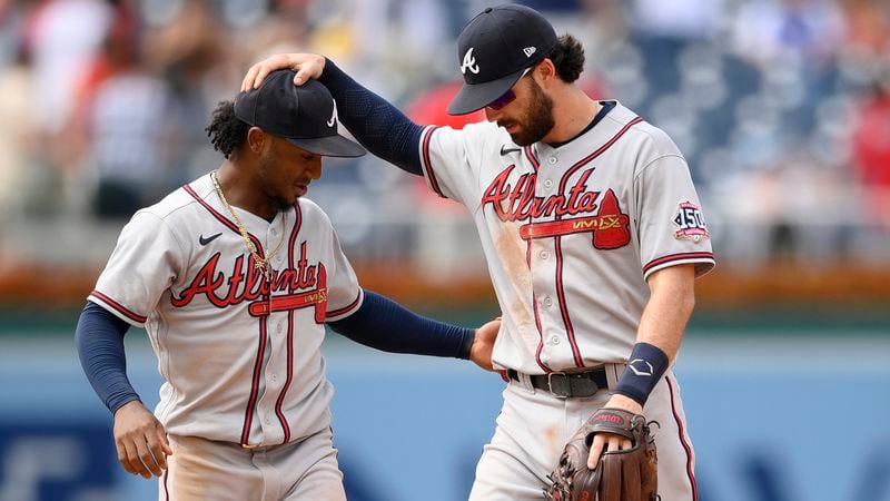 Braves second baseman Ozzie Albies (left) and shortstop Dansby Swanson celebrate 6-5 win over the Washington Nationals, Sunday, Aug. 15, 2021, in Washington. (Nick Wass/AP)