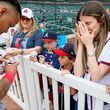 Leslie Tessler gets emotional as she sees Atlanta Braves shortstop Orlando Arcia signing an autograph to her son Lucas Torino (8) before the game against the Chicago Cubs at Truist Park on Tuesday, May 14, 2024. 

(Miguel Martinez/ AJC)