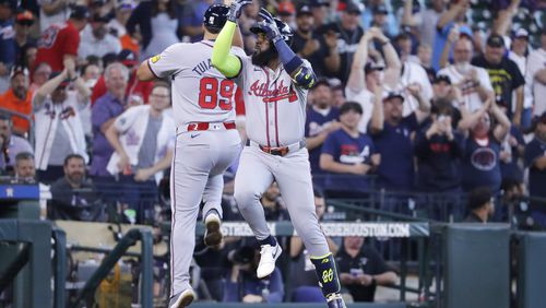 Marcell Ozuna celebrates with third base coach Matt Tuiasosopo (89) as he round the bases during the second inning of Wednesday's game against the Astros in Houston. (AP Photo/Michael Wyke)