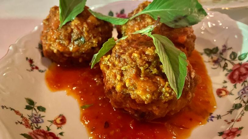 The hint of lemongrass mixed with ground pork sausage takes So So Fed's sai gok meatballs, ladled with mild tomato sauce, into unexpected territory. Ligaya  Figueras/ligaya.figueras@ajc.com