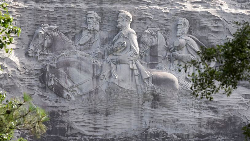 Members of the Atlanta chapter of the NAACP said Wednesday during a protest at Stone Mountain Park that the carving of three Confederate leaders must come down. (AP Photo/John Bazemore, File)