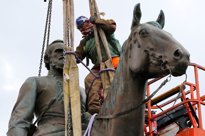 FLE - A worker attaches a rope as they prepare to remove the statue of Confederate General Stonewall Jackson from its pedestal on July 1, 2020, in Richmond, Va. Shenandoah County, Virginia's school board voted 5-1 early Friday, May 10, 2024, to rename Mountain View High School as Stonewall Jackson High School and Honey Run Elementary as Ashby Lee Elementary four years after the names had been removed. AP Photo/Steve Helber, File)