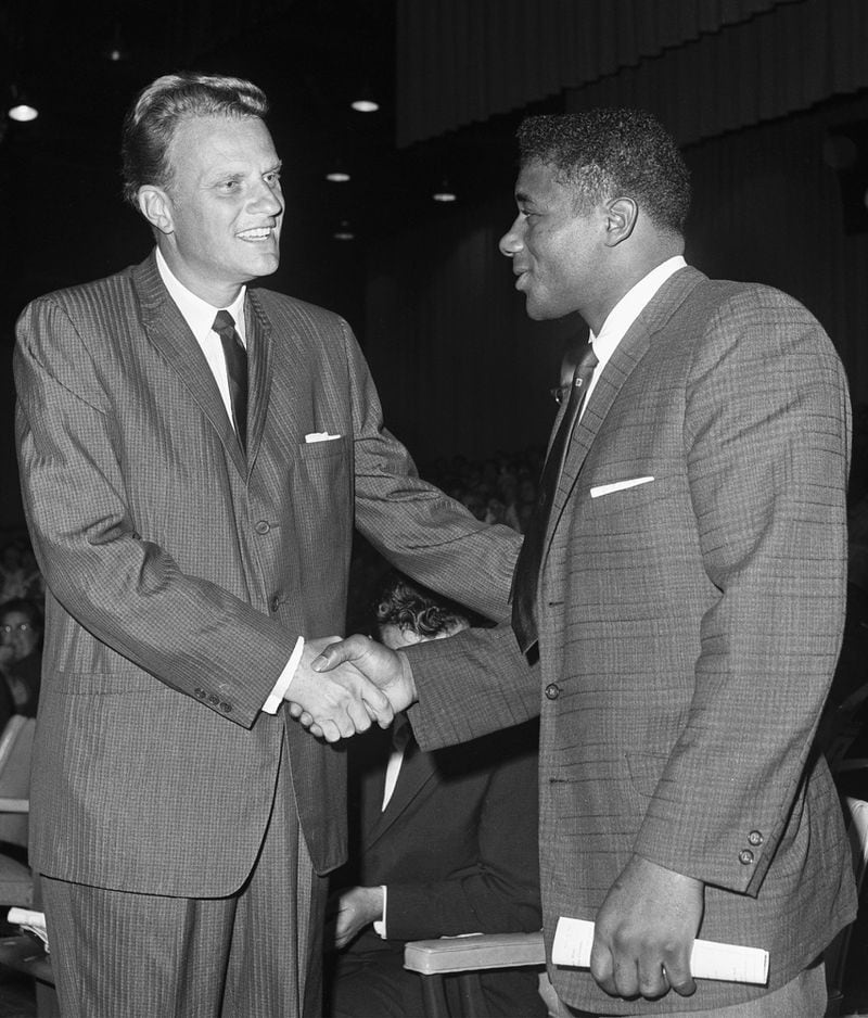 Shaking the hand of heavyweight champion Patterson, who attended one of his prayer meetings in 1961.
