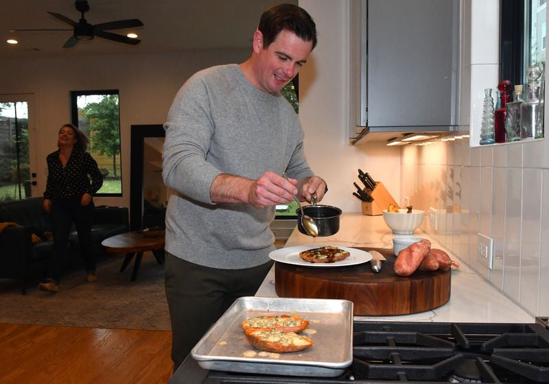 Joey Ward, executive chef and owner of Southern Belle and Georgia Boy in Atlanta, works on one of his favorite at-home dishes, Baked Sweet Potato with Blue Cheese, Maple and Bacon. (Styling by Joey Ward / Chris Hunt for the AJC)