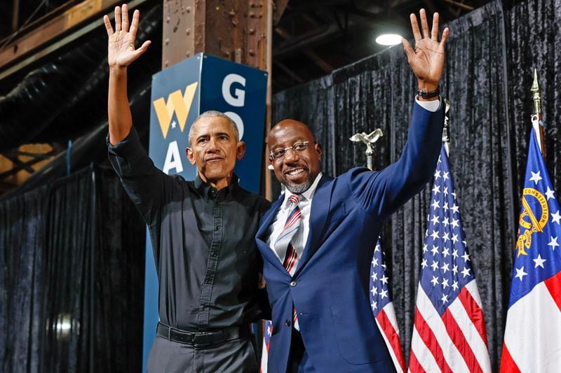 Former President Barack Obama and Sen. Raphael Warnock wave to supporters during a campaign rally at Pullman Yards in Atlanta on Thursday, December 1, 2022. (Natrice Miller/natrice.miller@ajc.com)  